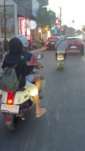 Two-person scooter spotted on busy Ubud street