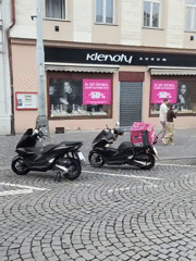 Evening street activity recorded in Prague cobblestone district