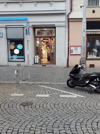 Evening street activity recorded in Prague cobblestone district