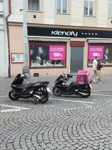 Evening street activity recorded in Prague cobblestone district