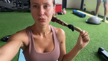 Sweaty gym pause on green turf after a workout