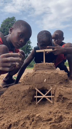 Children build sandcastles during family playtime in Igbara, Nigeria