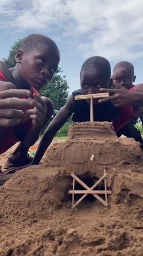 Children build sandcastles during family playtime in Igbara, Nigeria
