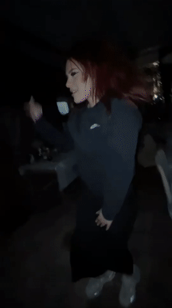 Woman with red hair dances in Zlatograd, Bulgaria