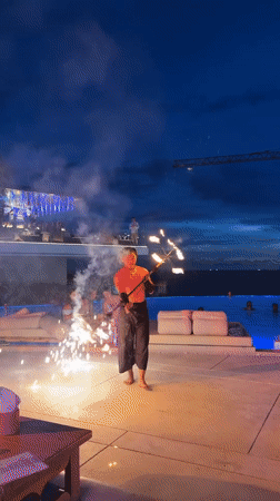 Poolside fire performance lights up a Karon night