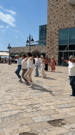 Outdoor group dance routine on a Budva plaza