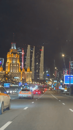 Evening traffic captured on Moscow street from moving vehicle