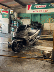 Early morning motorcycle wash service documented in Nha Trang