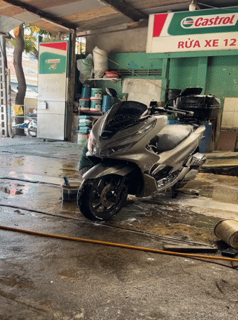 Early morning motorcycle wash service documented in Nha Trang