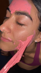 Woman receives pink face mask treatment in Puebla