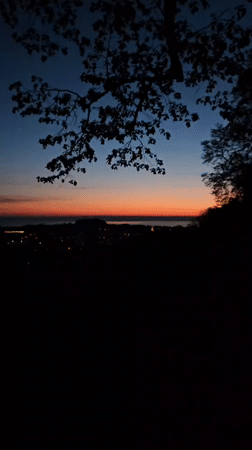Dawn breaks over St. Gallen cityscape, captured on video