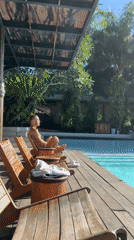 Man relaxes poolside in Petulu, Indonesia