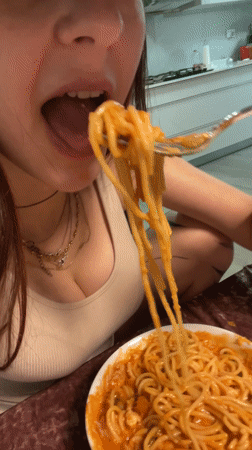 Woman cooks homemade spaghetti dinner in Raanana kitchen