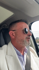 Middle-aged man spotted driving through Milan in business attire