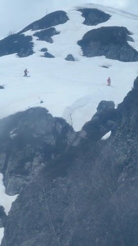 Skiers descend snowy slopes in Estosadok, Russia