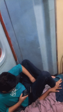 Overnight train passengers rest during journey through Igatpuri