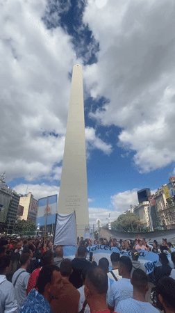 Woman takes selfie in neon mirror at Buenos Aires pilates studio