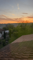 Sunrise captured over Bulgarian countryside from rooftop in Zornitsa