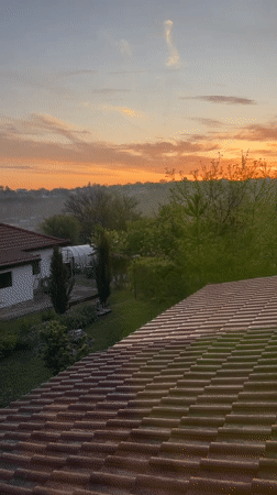 Sunrise captured over Bulgarian countryside from rooftop in Zornitsa