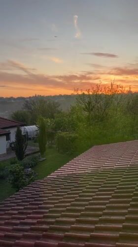 Sunrise captured over Bulgarian countryside from rooftop in Zornitsa