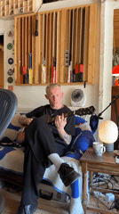 Young guitarist plays acoustic music in Runnymede chair