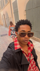 Person records selfie video on narrow street in Toulon