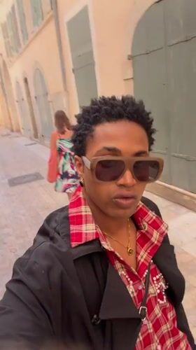 Person records selfie video on narrow street in Toulon