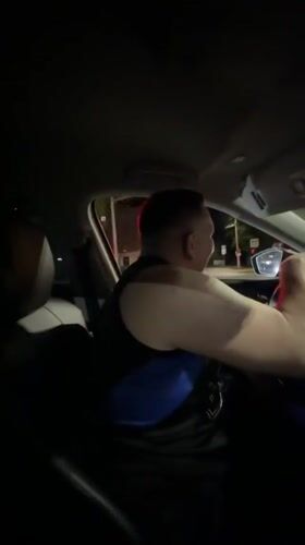 Couple enjoys music during nighttime drive through Malinovka intersection