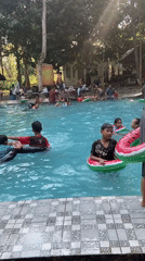 Crowded outdoor pool day in Mlowokarangtalun, Indonesia