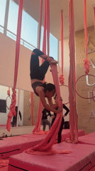 Woman practices aerial silk acrobatics in Mexican dance studio