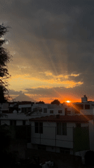 Dramatic sunset breaks through storm clouds over Cholula, Mexico