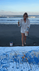 Body-contact canvas painting session on a Tabanan black sand beach