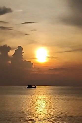 Sunset on the Lhokseumawe shore, fishing boats and all