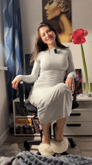Woman in gray dress documented in home office setting