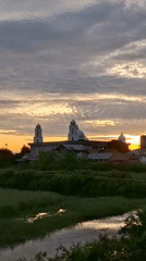 Sunset silhouettes mosque in Indonesian village, tanker truck nearby