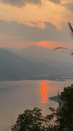 Sunset observed over lake and mountains in Pokhara, Nepal