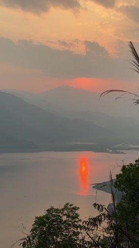 Sunset observed over lake and mountains in Pokhara, Nepal