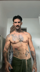 Tattooed man takes bathroom selfies in Chalong, Thailand