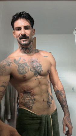 Tattooed man takes bathroom selfies in Chalong, Thailand