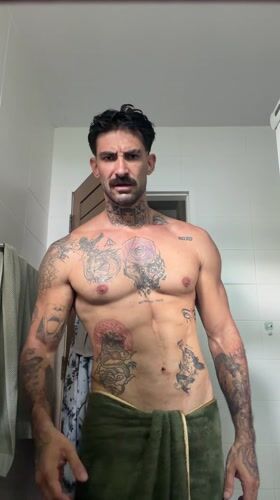 Tattooed man takes bathroom selfies in Chalong, Thailand
