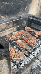 Meat and sausage grilling in brick barbecue structure, Dortmund