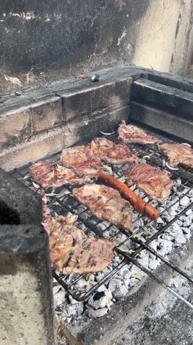 Meat and sausage grilling in brick barbecue structure, Dortmund