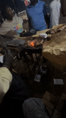 Nighttime street barbecue gathering documented in Bukuru, Nigeria