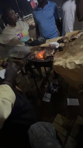 Nighttime street barbecue gathering documented in Bukuru, Nigeria