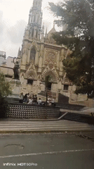 Church with spire documented in Caracas, people visible outside