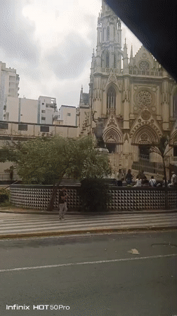 Church with spire documented in Caracas, people visible outside