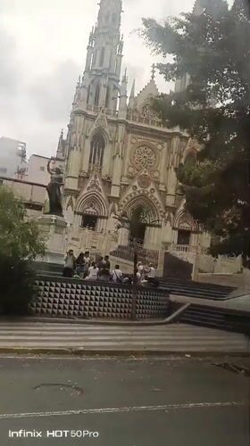 Church with spire documented in Caracas, people visible outside