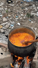 Woman cooks with makeshift stoves in Ajara, Nigeria