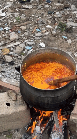 Woman cooks with makeshift stoves in Ajara, Nigeria
