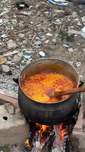 Woman cooks with makeshift stoves in Ajara, Nigeria